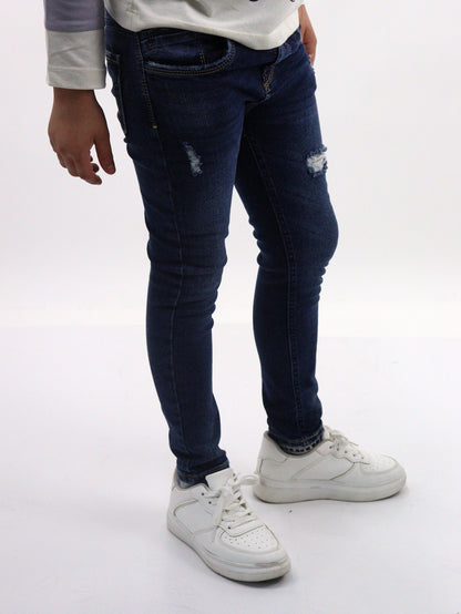 Jeans skinny de color azul oscuro con destrucción