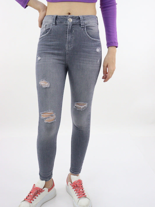 Jeans skinny tiro alto de color gris con destrucción