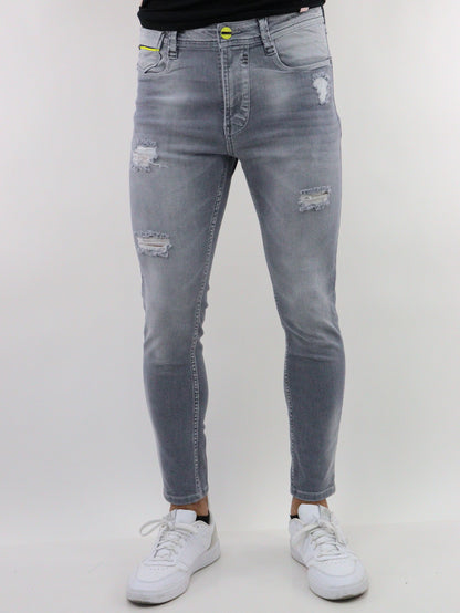 Jeans skinny de color gris con destrucción