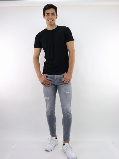 Jeans skinny de color gris con destrucción