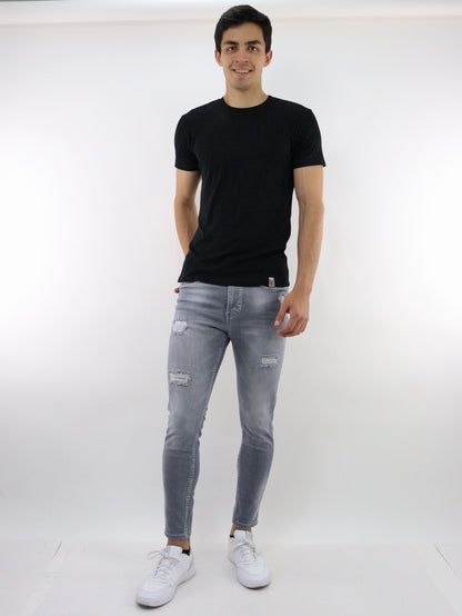 Jeans skinny de color gris con destrucción